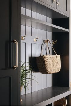 a basket hanging from the side of a book shelf