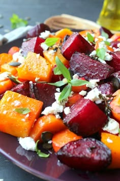 a plate with beets, carrots and feta cheese