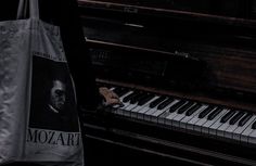 a bag sitting on top of a piano with the words mozzart printed on it