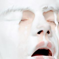 a close up of a child's face covered in milk