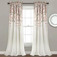 a white curtain with pink flowers on it in front of a gray wall and mirror