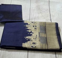 Color - A stunning shade of Deep Blue - a shot colour with a warp of Black and a weft of Navy Blue. Technique - Classic handwoven Banarasi art passed down through generations of weavers Fabric - Soft as butter, pure Katan silk Speciality - The glorious outline of Varanasi's Ghats, lovingly handwoven on a base of resplendent silk in Roopa Sona or Gold and Silver zari. Incredible in its details and a mirror to the splendour of Banaras as seen from the river Ganga.   But it's not just about the look. This saree is woven from Katan silk, known for its buttery-soft texture and luxurious drape. It feels like a whisper against your skin, a caress of pure elegance. Wearing a Banarasi saree is more than just fashion. It's a statement. It's a connection to India's rich textile heritage. It's a way t Designer Blue Katan Silk Saree, Blue Katan Silk Saree With Zari Weaving, Luxury Katan Silk Fabric For Saree, Blue Unstitched Katan Silk Saree, Luxury Blue Katan Silk Saree, Katan Silk, Pure Elegance, Banarasi Saree, Banarasi Sarees