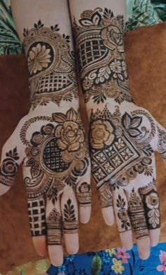 two hands with henna designs on them