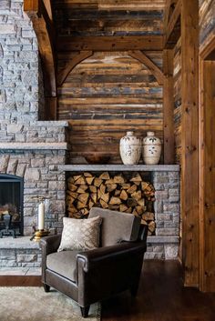 a living room filled with furniture and a fire place in front of a stone fireplace