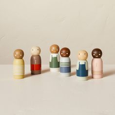 a group of small wooden dolls standing next to each other