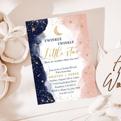 a pink and blue baby shower with gold stars on it, next to a card that says twinkle the little star