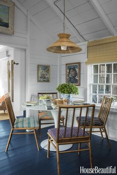 a dining room with blue floors and white walls