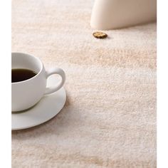 a cup of coffee sitting on top of a white saucer