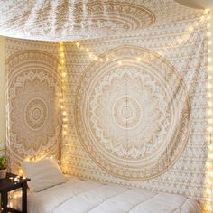 a bed with a large tapestry hanging over it's headboard