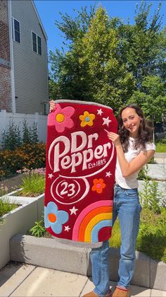 a woman standing next to a large sign