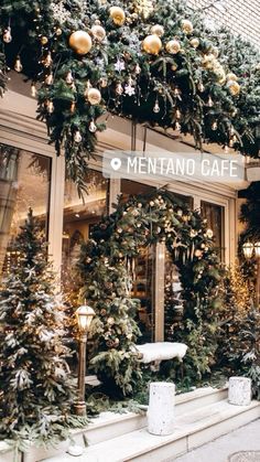 a store front decorated with christmas trees and garlands for the holiday season is pictured in this image