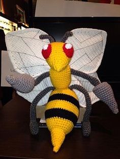 a crocheted bee sitting on top of a table