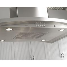 a kitchen hood with three lights on the top and two under cabinet doors in the background