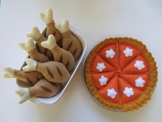 an orange and white cake next to a giraffe shaped pie