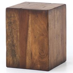 a square wooden object sitting on top of a white surface