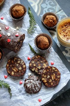 several chocolate desserts are on the table next to a cup of coffee and some candy