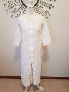 Soft cotton Chikankari kurta for women is an airy and lightweight companion for a hot summer day. Lucknow Chikan Kurti/Tunic /Kurta is one of the gorgeous attire for working from home.This beautiful Hand embroidered tunic, kurta is ideal for any functions/parties. If you want a classic look then pair it with leggings, skinny jeans.This is a contemporary reflection of traditional India Chikan embroidered ethics which had originated centuries ago in Lucknow.Chikankari being the exquisite needlewor White Cutdana Blouse For Eid, Fitted Off White Kurta With Floral Embroidery, Spring Wedding Traditional Cotton Wear, Wedding Tops With Chikankari Embroidery For Eid, Eid Wedding Tops With Chikankari Embroidery, Spring Wedding Straight Kurta Top, Wedding Chikankari Embroidery Top For Eid, Unstitched White Traditional Wear For Spring, Traditional White Straight Kurta Top