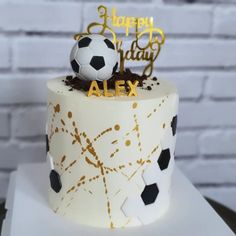 a birthday cake with a soccer ball on top and happy birthday alex written in gold