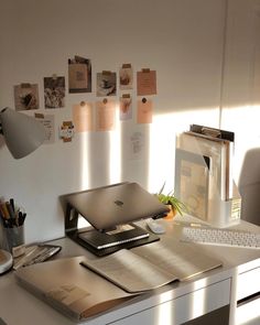 a laptop computer sitting on top of a white desk