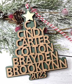 a wooden christmas tree ornament with the words, candy cane and cotton in it