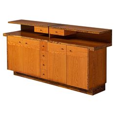 a large wooden cabinet with two drawers on one side and an open shelf on the other