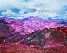 the mountains are covered in pink and purple hues