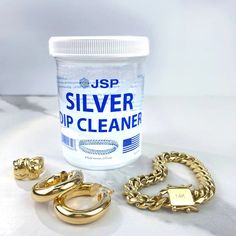 a jar of silver up cleaner next to gold chains