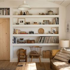 a living room filled with furniture and bookshelves