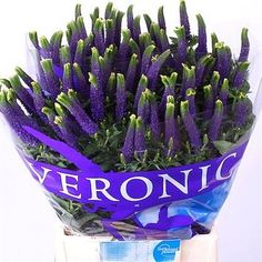 a bouquet of purple flowers wrapped in cellophane with the words veronic on it