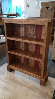 a wooden bookcase sitting on top of a hard wood floor