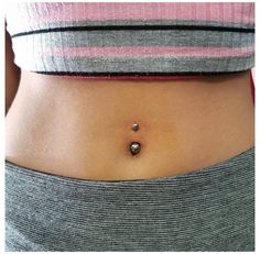 a woman's stomach with two small balls on it, and the bottom part of her belly