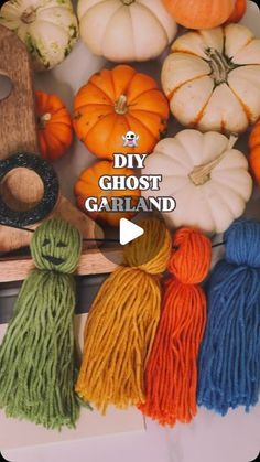 several yarns and pumpkins are arranged on a table with the words diy ghost garland