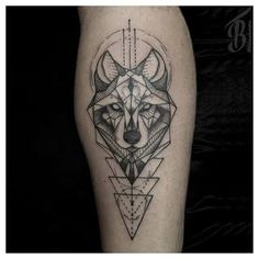 a black and white photo of a tattoo on someone's leg with an animal head