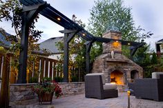 an outdoor fireplace and seating area is lit up