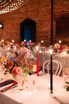 the table is set with flowers and candles