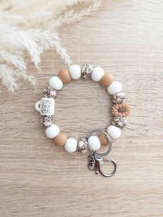 a white and brown beaded bracelet with a keychain that says i love you more