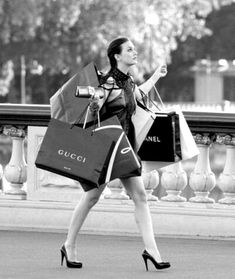 a woman walking down the street carrying shopping bags