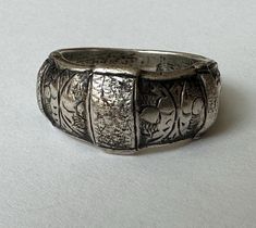 another piece that i've had sitting here with me for a long time because i adore it... a sterling ring from Siam, likely in the 1940's.  it has wondrous texture and hand engraving and a bit of a dome.  it has nice weight and is marked Siam Sterling.  it's also marked 7, for the size, but due to its width i prefer it as a 6.75.  it has some wear on the inner band but mostly very nice condition. size:  6.75-7 height of face;  3/8" width of inner band:  between 2 and 3/16" weight:  9.6g Here With Me, Metal Work, Hand Engraving, Sterling Ring, Metal Working, Band Rings, Favorite Jewelry, Beauty Book, San Francisco