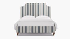 a bed with striped upholstered headboard and foot board