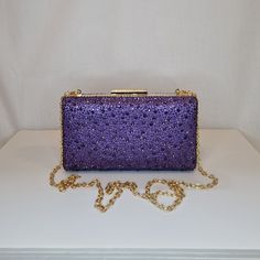 Womens purple crystal encrusted luxury evening clutch bag with gold embellishment and top closing clasp Can be used with or without long shoulder chain (included) size approx- H 10.5cm x W 18.5cm Optional Dust Bag: White lightweight soft polyester portable travel dust bag pouch, suitable for protecting items from dust, dirt, hairs and scratches when not in use size approx- L 47cm x W 31.5cm Material: 100% polyester Please note, there is a cut in the top corner of the bag. In order to reveal the Gold Embellishment, Crystal Diamond, Shoulder Chain, Purple Crystals, Evening Clutch Bag, Portable Travel, Evening Clutch, Diamond Crystal, White Bag