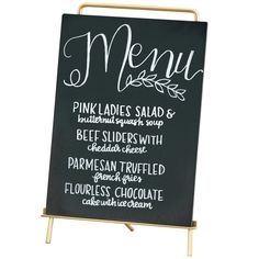 a blackboard sign with the words menu written in white chalk and gold metal frame