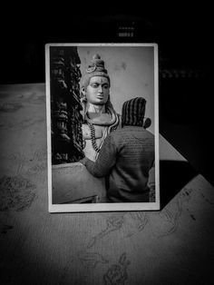 a black and white photo of a man holding a woman's head in the dark