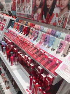 the shelves are full of lipsticks and other beauty products for sale in a store