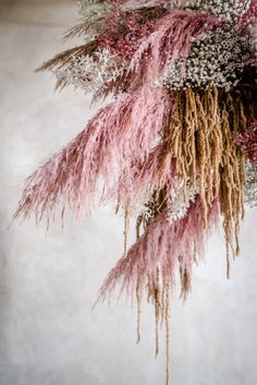 pink and white flowers are hanging from the ceiling