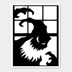 a black and white silhouette of a lion looking out the window