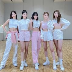 four girls in white and pink outfits posing for the camera