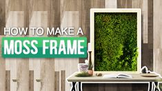 there is a moss frame on the wall next to a desk with an open book