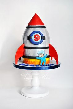 a cake shaped like a rocket ship on top of a plate