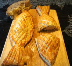 three pieces of pie sitting on top of a wooden cutting board