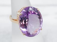 This ring is truly gorgeous! A large and beautiful saturated purple amethyst sits in the center, with an amazing cut and vibrant color that flickers with bright pops of violet! The stone is expertly cut to really display the stone’s color and sparkle. The simple mounting and prongs are all this stone needs to frame it to perfection!Metal: 14K Yellow GoldGem: Amethyst 18.97 CaratsGem Measurements: 10.3 x 15.5 mm, OvalRing Size: 7Marks: “14K” Stamped on the inside band Classic Formal Amethyst Ring With Large Stone, Formal Amethyst Ring With Large Stone, Round Amethyst Jewelry With Large Stone, Large Amethyst Ring, Luxury Amethyst Ring With Polished Finish, Platinum Halo Ring, Rose Gold Halo Ring, Opal Statement Ring, Amethyst Cocktail Ring